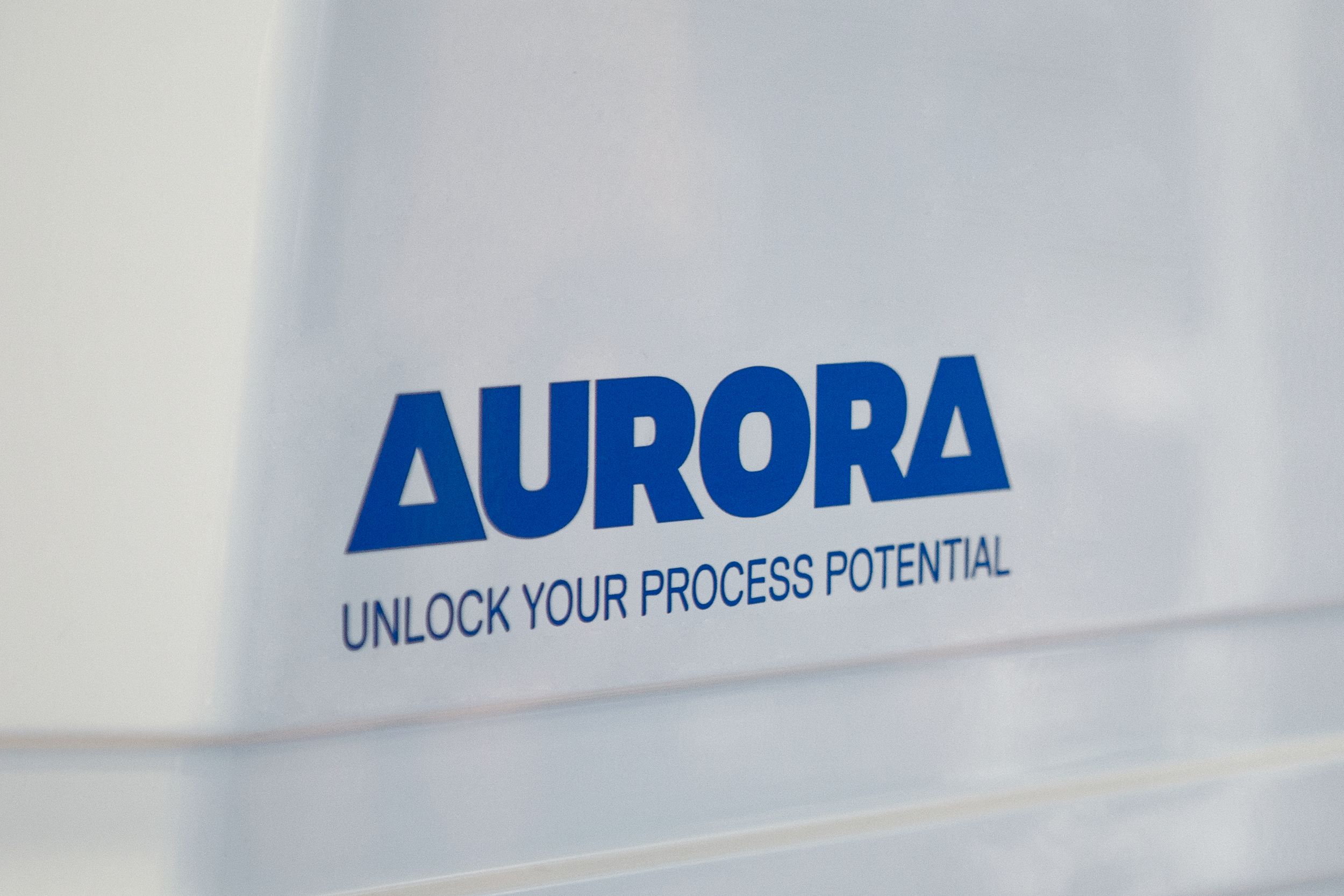 Close up of Aurora logo seen on the side of a packaging machine
