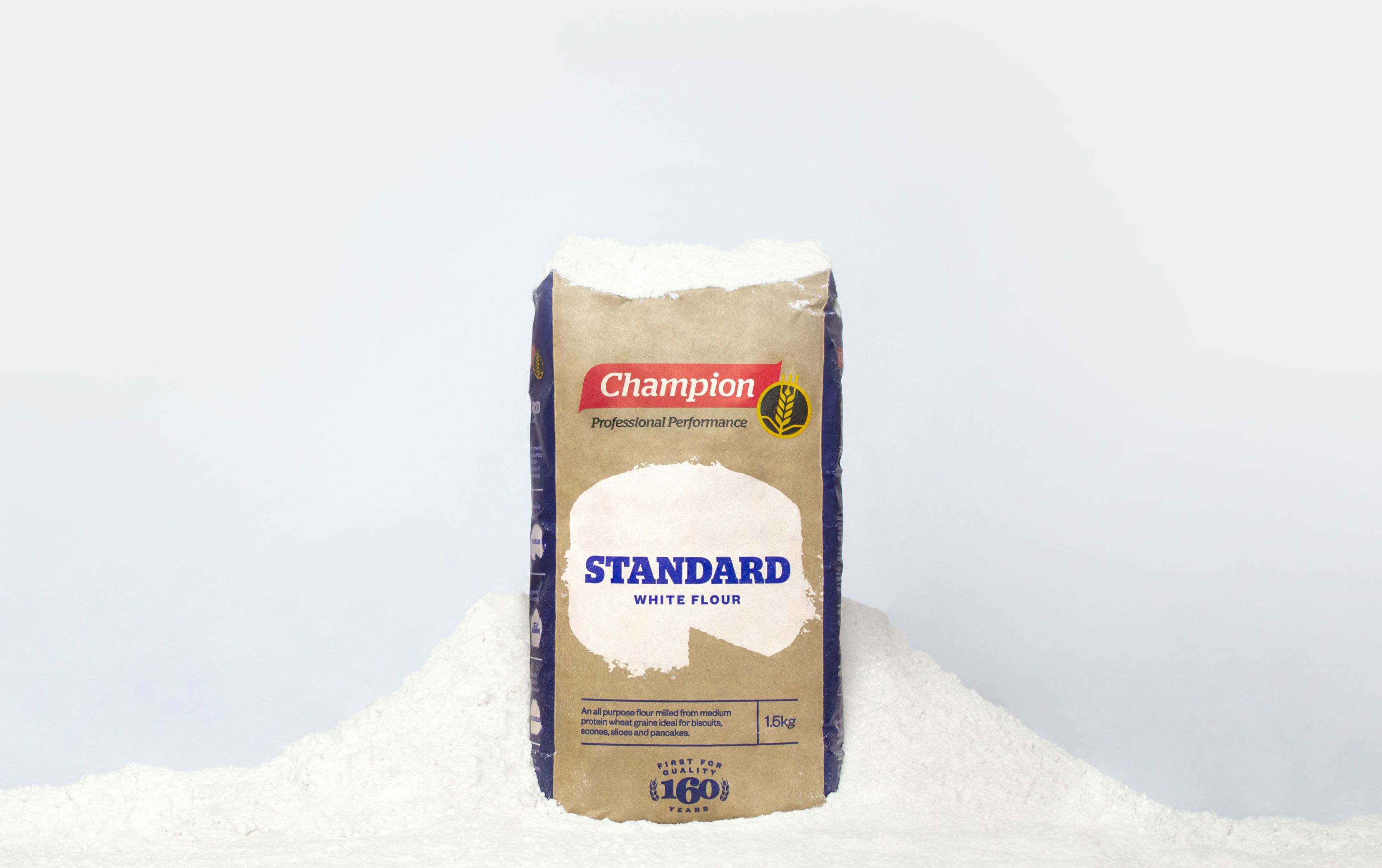 Bag of Champion Flour covered in and surrounded by flour