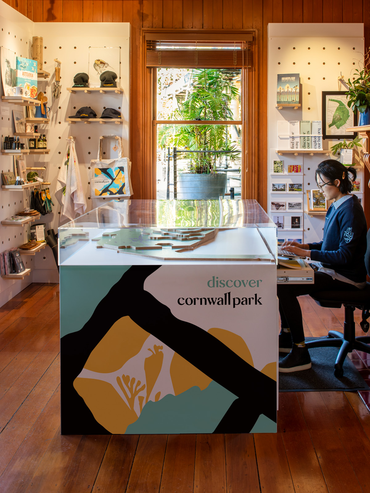 Employee working inside the Cornwall Park Shop
