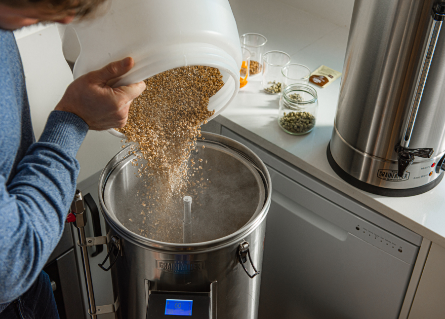 photograph of person making homebrew beer